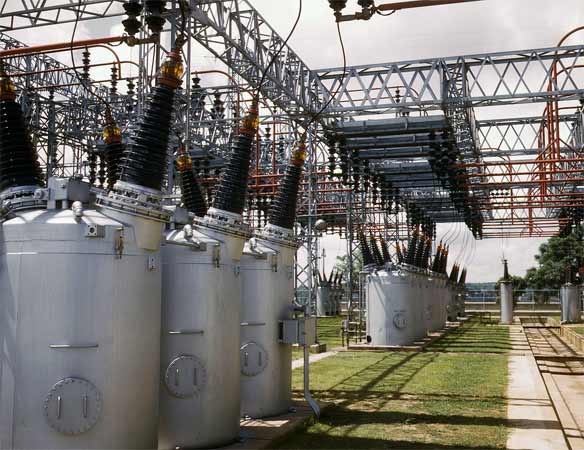 Oil circuit breakers in a switchyard. Photo: Wikimedia.